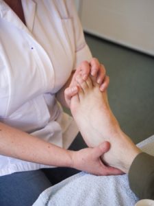 professional reflexologist giving reflexology treatment